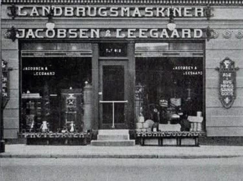 The original Jacobsen & Leegaard storefront with agricultural machinery signage above its windows